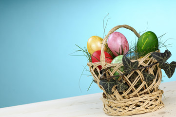 one easter basket with colored eggs