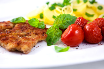Schnitzel with potatoes and tomatoes