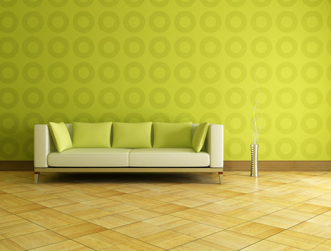 white and green couch in front a geometrical wallpaer