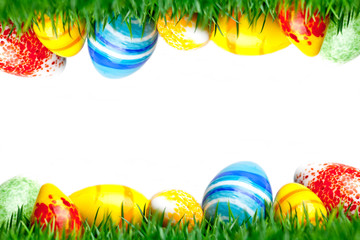 Easter eggs in green grass isolated on white background
