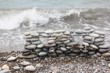 construction of many pebbles on sea coast near water