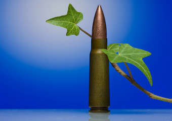 Gun machine cartridge and liana stalk- antiwar concept