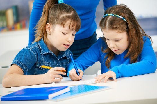 Schoolgirls learning in classroom
