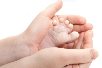 baby foot in parent's hands