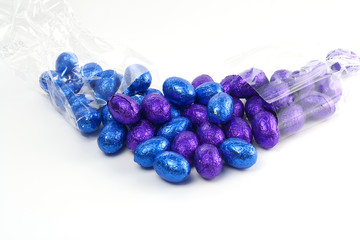 Blue and purple easter eggs with transparant bag on white