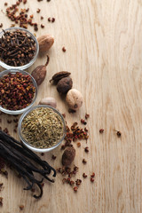 Assortment Spices border on the wood background