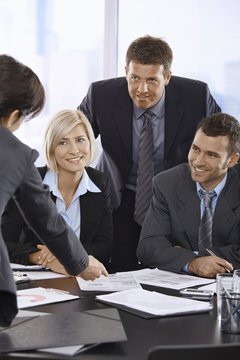 Smiling business team talking in office