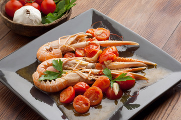 dish with scampi and tomatoes close up