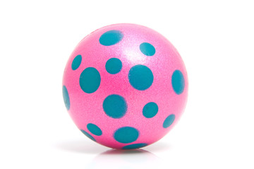 Pink dotted ball over white background