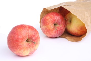 Red apples in a paper bag