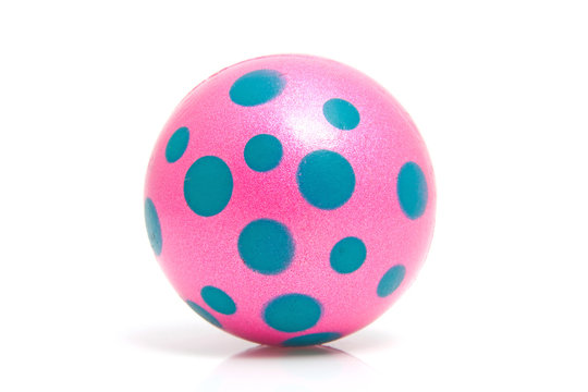 Pink dotted ball over white background
