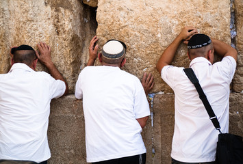 Three Jewish men at the Western Wall in Jerusalem