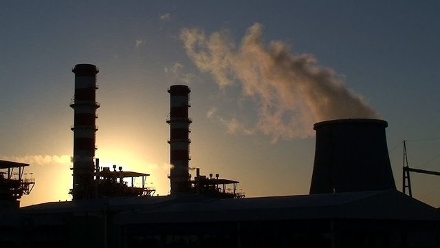 Power plant at sunset smokestacks