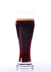 Alcohol dark beer glass with froth isolated on a white backgroun