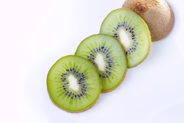 Fototapeta premium Kiwi slices on white plate