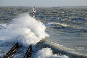 Violent waves flooding a pier during a storm