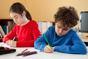 Young girl and boy learning at home