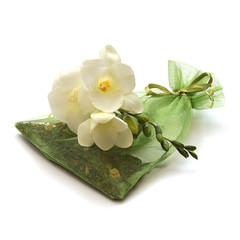 Obraz na płótnie Canvas bag of tea leafs with flower