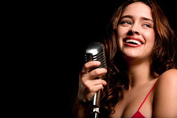 Beautiful singer singing with microphone