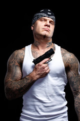 Tattooed gangster with gun