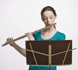 Teenage girl playing flute © AVAVA