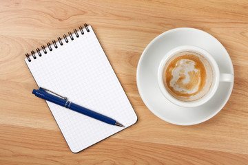 Blank notepad with pen and empty coffee cup