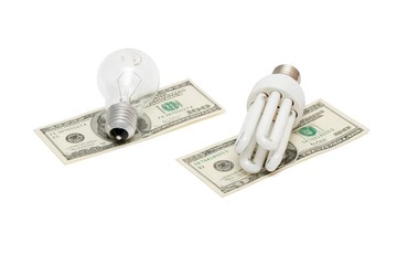 Energy save lamp versus bulb on dollar bills isolated