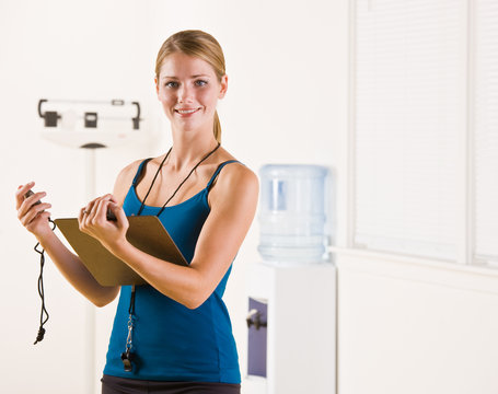 Woman Holding Stopwatch And Clipboard