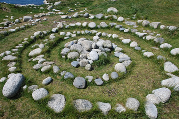magic Celtic spiral of life made of pebble rocks in nature