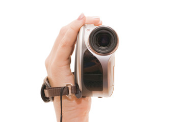 Videocamera in a female hand isolated on white