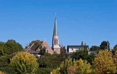 Fototapeta premium Steeple Over Trees in Small Town