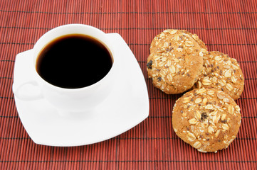 Coffee with cookies on red background