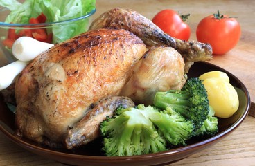 Chicken grill with potatoes and broccoli.