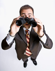 Businessman looking through binoculars