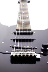 Black electric guitar on white background