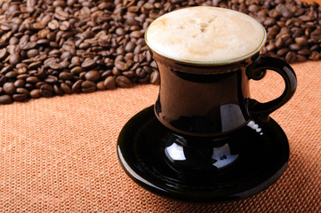 Background of the coffee beans and sackcloth with cup