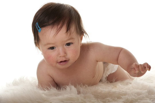 Pacific Islander Baby Girl Smiling Whilte Learning To Crawl