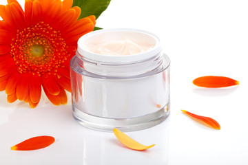 Face cream and gerbera flowers