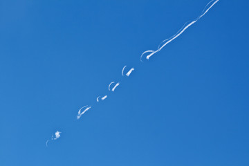 blue sky with condensation trail of aircraft