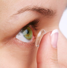 human eye with corrective lens on a white