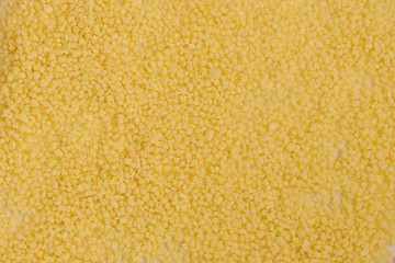 Fond et arrière plan de semoule de blé jaune à couscous