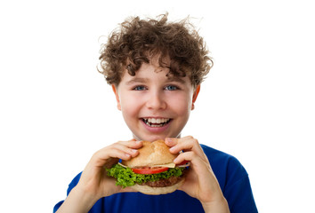 Boy eating big sandwich isolated on white