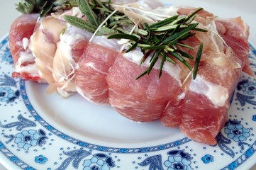 Rolled pork on a dish and ready to be cook