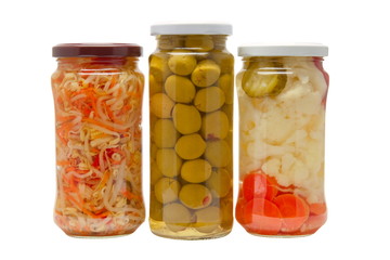 Glass jars with marinated vegetables  isolated on the white back