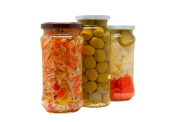 Glass jars with marinated vegetables  isolated on the white back