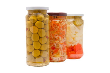 Glass jars with marinated vegetables  isolated on the white back