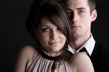 Young Couple against Dark Background