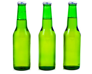 Three green beer bottles in a white background