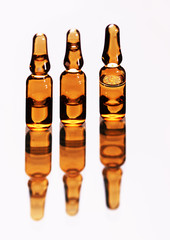 Three medical ampule reflection, isolated