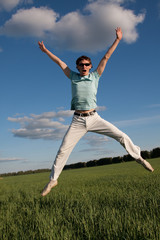 Fototapeta na wymiar Jumping happy young man
